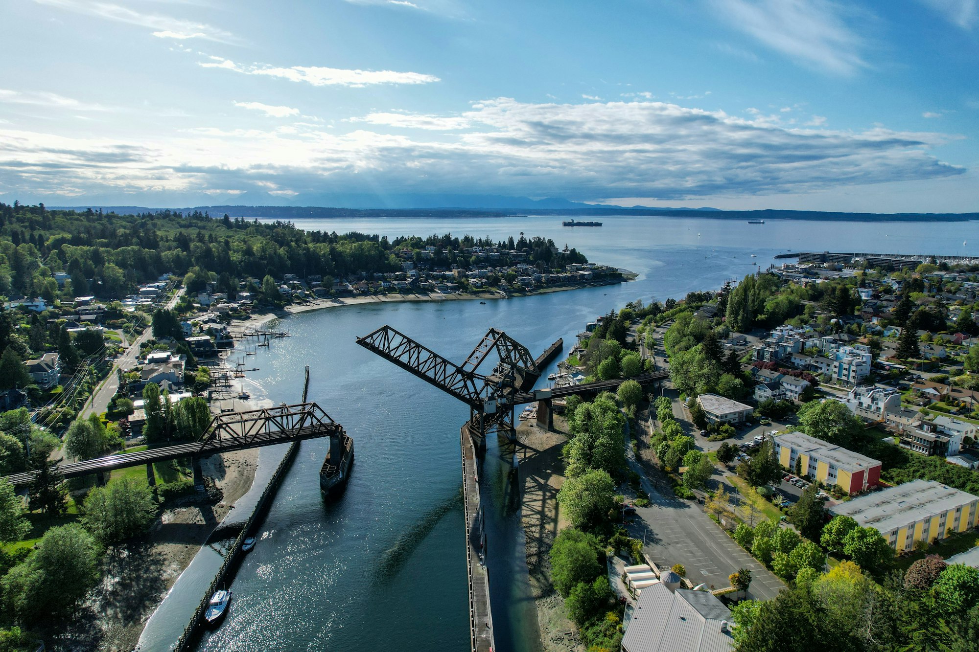 Raised railroad train draw bridge over the Ballard cut waterway connecting Puget Sound to Lake Union